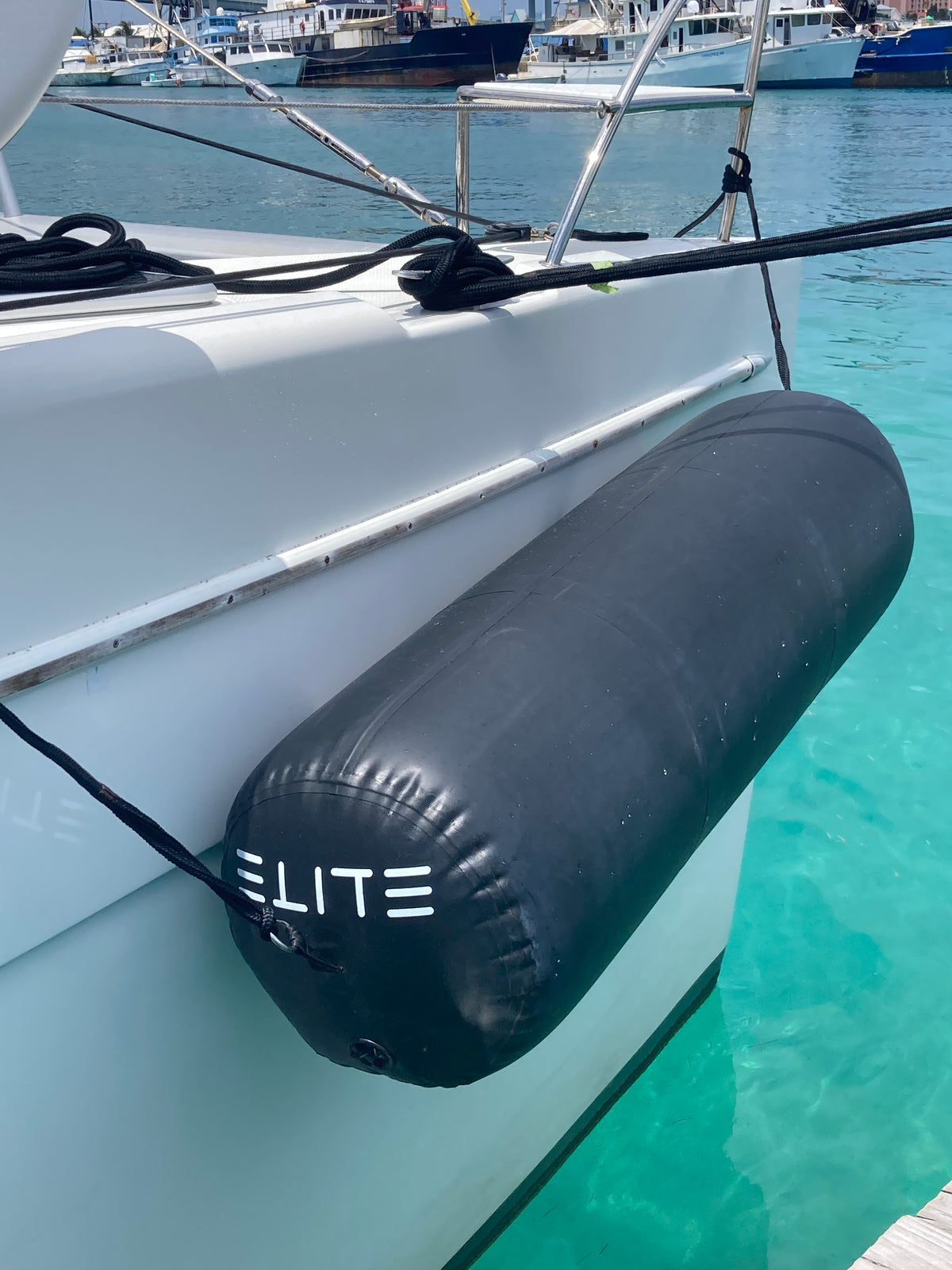 An ELITE cylindrical fender protecting a white yacht in clear turquoise water.